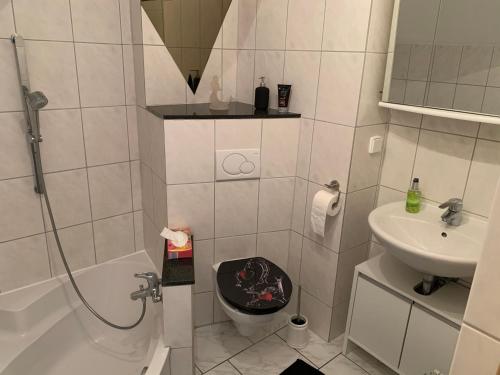 a bathroom with a shower and a toilet and a sink at City Apartment 1 in Brühl