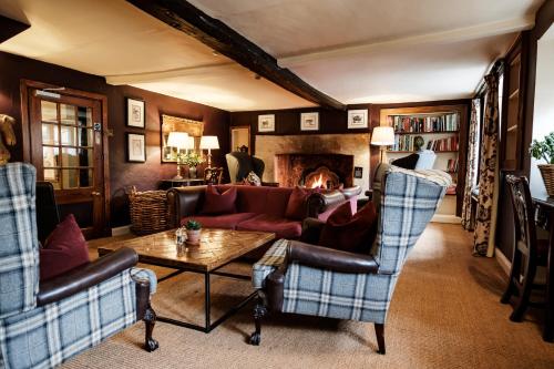 a living room with a couch and a fireplace at The Lamb Inn in Burford