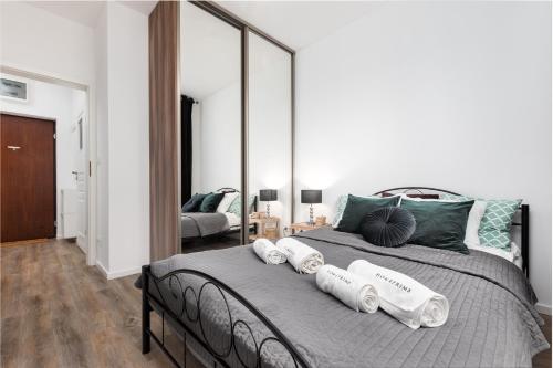a bedroom with a bed with a large mirror at Rakowska 14A 1 bedroom by Homeprime in Warsaw
