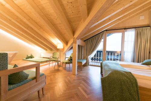 a room with a bed and a large window at Biohotel Garmischer Hof in Garmisch-Partenkirchen