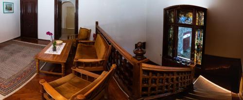 a room with stairs and a table and a window at Vila Retezat Sinaia in Sinaia