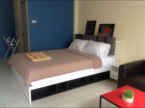 a large bed in a room with a couch at Phuket Town Budget House - Aircon Room #1 in Ban Lo Long