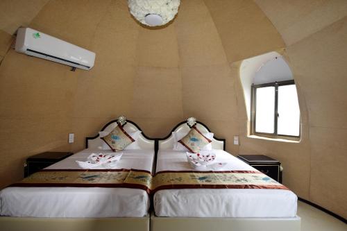 a bedroom with a bed in a small room at The Lion Kingdom Sigiriya in Sigiriya