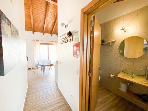 a bathroom with a sink and a toilet in a room at Casa do Sapateiro - No centro histórico de Aljezur in Aljezur