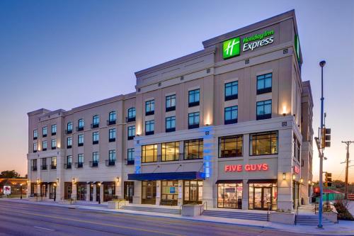 a large building with a msg costs sign on it at Holiday Inn Express & Suites - Kansas City KU Medical Center by IHG in Kansas City