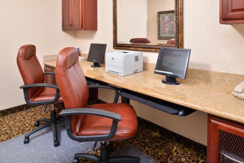 a conference room with two chairs and a desk with a computer at Holiday Inn Express Hotel & Suites Las Cruces by IHG in Las Cruces