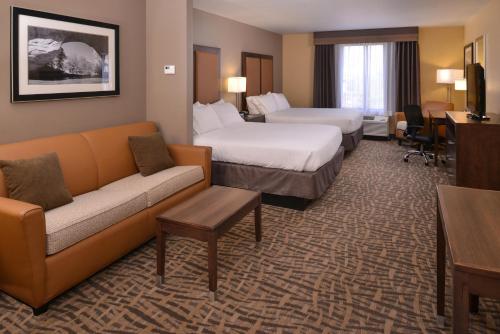 a hotel room with two beds and a couch at Holiday Inn Express & Suites Page - Lake Powell Area by IHG in Page