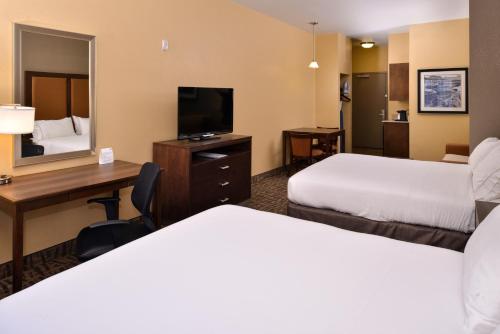 a hotel room with two beds and a desk and a television at Holiday Inn Express & Suites Page - Lake Powell Area by IHG in Page