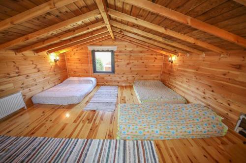 a room with two beds in a log cabin at Çınarhan Villas in Agva