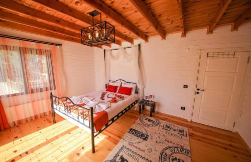 a bedroom with a bed in a room with a door at Çınarhan Villas in Agva