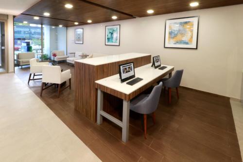 a office with a desk and chairs and a table at Holiday Inn Express & Suites - Playa del Carmen by IHG in Playa del Carmen