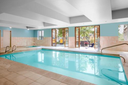 a large swimming pool with blue water in a building at Holiday Inn Express Hotel & Suites Ontario, an IHG Hotel in Ontario