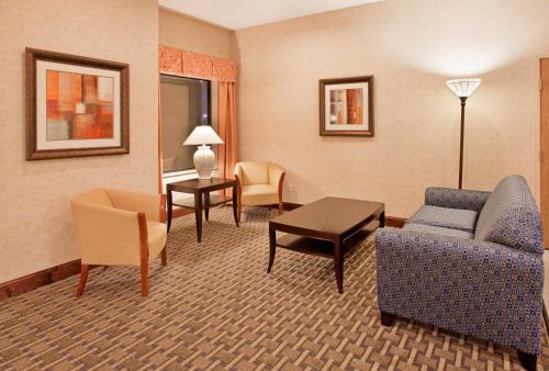 a living room with a couch and chairs and a table at Holiday Inn Express Kansas City Liberty Missouri by IHG in Liberty