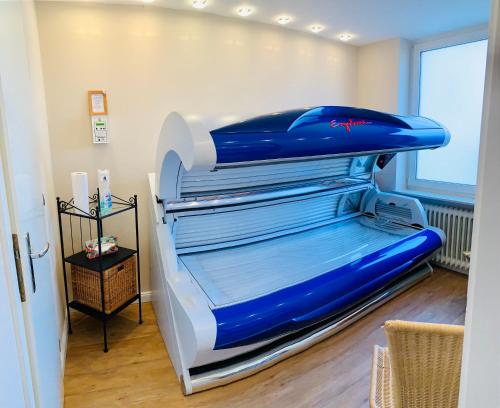 a large blue and white bed in a room at Aparthotel Kleine Perle in Cuxhaven
