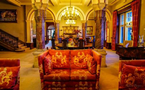 
a living room filled with lots of furniture at Camelot Castle Hotel in Tintagel
