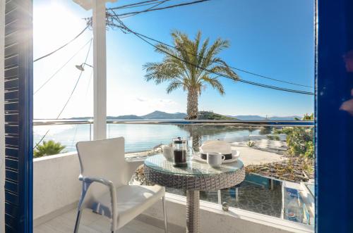 a balcony with a table and a view of the water at Saint George Hotel in Naxos Chora