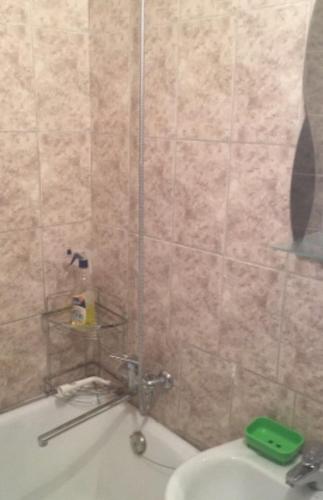 a bathroom with a shower with a tub and a sink at Хостел 24 in Vinnytsya