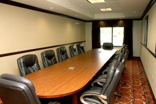 a conference room with a long wooden table and chairs at Holiday Inn Express & Suites Cumberland - La Vale by IHG in La Vale