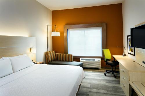 a hotel room with a bed and a window at Holiday Inn Express & Suites - Medford by IHG in Medford