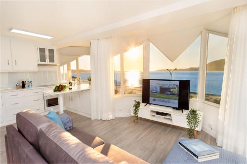 a living room with a couch and a flat screen tv at BestVillas Foz do Minho in Caminha