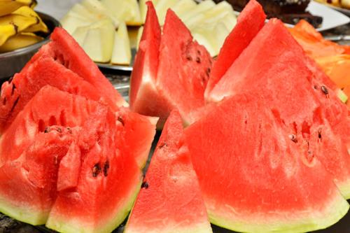 a group of red watermelon slices on a table at Carvalho's Hotel in Palmas