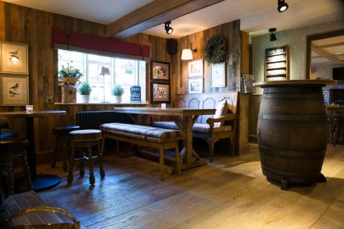a kitchen with a wooden table and a wooden table top at Red Lion Inn in Little Budworth