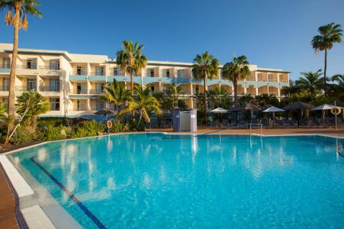 a large swimming pool in front of a hotel at IFA Altamarena by Lopesan Hotels in Morro del Jable