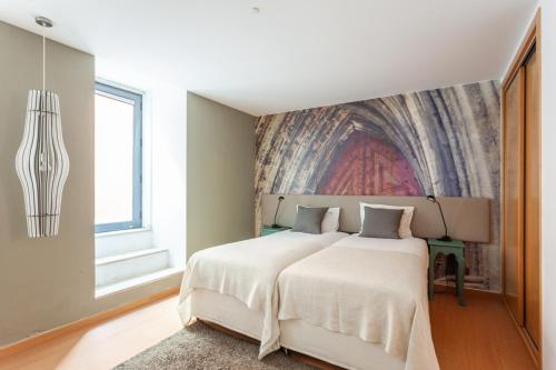 Säng eller sängar i ett rum på FLH Liberdade Terrace Apartment