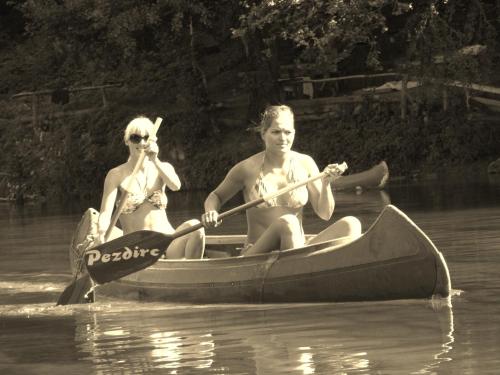 two people in a canoe on the water at RIVER KOLPA APARTMENT, Griblje ob reki Kolpi in Gradac