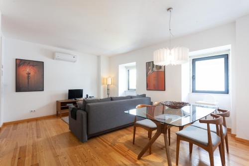 a living room with a couch and a table at FLH Liberdade Contemporary Flat in Lisbon