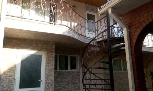 a spiral staircase on the side of a house with a door at Racu in Komrat