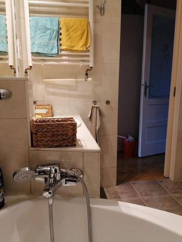 a bathroom with a bath tub and a sink at Bauhaus Astoria Hostel in Budapest