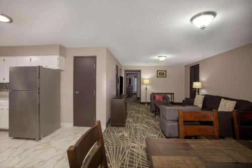 a living room with a couch and a refrigerator at La Quinta by Wyndham Branson in Branson