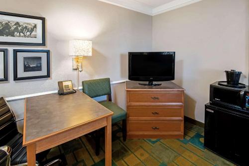 a hotel room with a desk and a tv and a room at La Quinta Inn by Wyndham Amarillo Mid-City in Amarillo