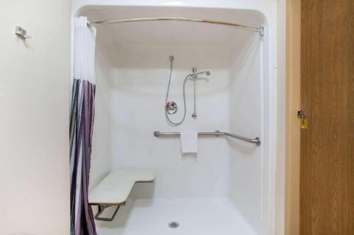 a bathroom with a shower with a toilet and a sink at La Quinta by Wyndham Springfield South in Springfield