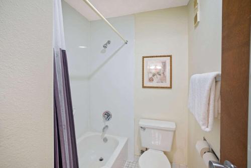 a bathroom with a tub and a toilet and a shower at La Quinta by Wyndham Jackson in Jackson