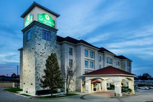 a hotel building with a sign on top of it at La Quinta by Wyndham DFW Airport West - Euless in Euless