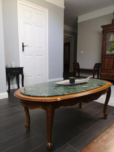 a table with a glass top on top of a room at Varga Villa in Orfű