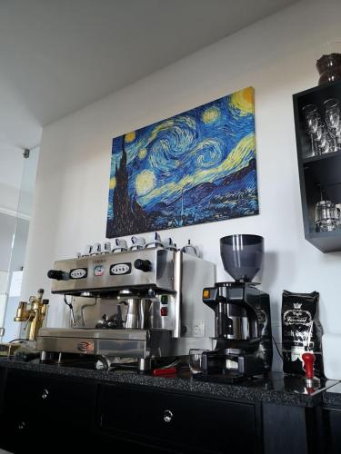 a kitchen counter with a stove and a painting on the wall at Varga Villa in Orfű