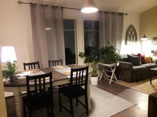 a living room with a table and chairs and a couch at B&B Minnan majoitus in Liminka