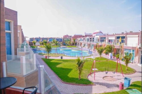 a view of a resort with a pool and a playground at Happiness Chalet 512 in Jeddah
