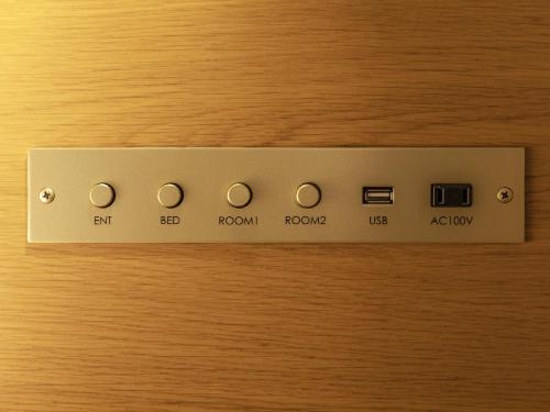 a remote control on top of a wooden table at Tokyu Stay Hakodate Asaichi Akarinoyu in Hakodate