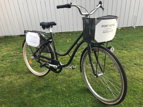 a bike with a basket parked on the grass at Port Hotel Apartments in Karlshamn