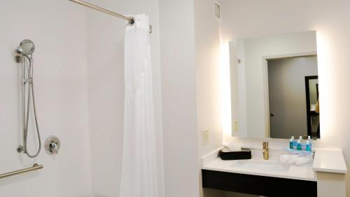 a white bathroom with a shower and a sink at Holiday Inn Express & Suites Kingston-Ulster by IHG in Lake Katrine