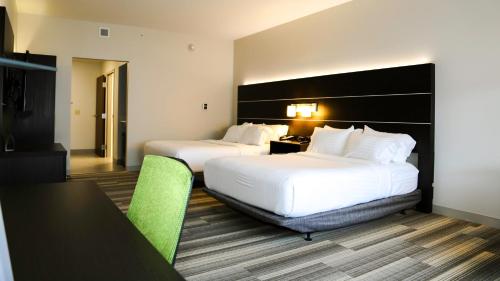 a hotel room with two beds and a table and chairs at Holiday Inn Express & Suites Kingston-Ulster by IHG in Lake Katrine
