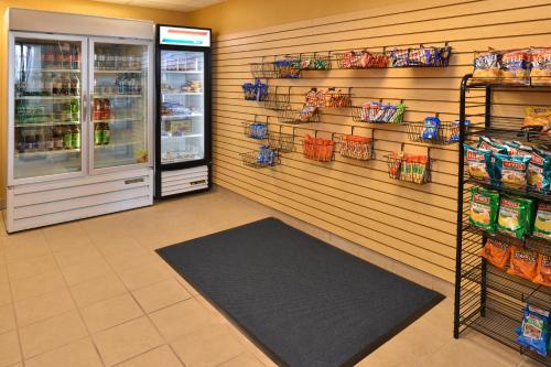 a store aisle with a refrigerator and shelves of food at Holiday Inn Express & Suites - Ocean City by IHG in Ocean City