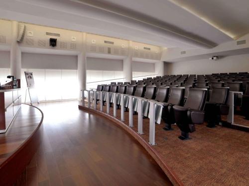 an empty room with black chairs in a building at Mercure Montpellier Centre Comédie in Montpellier