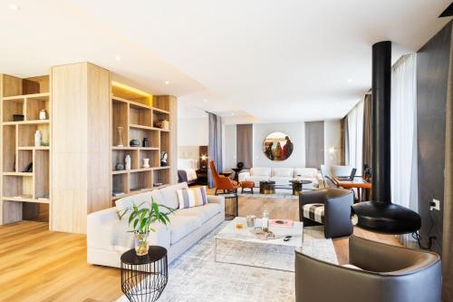a living room with a white couch and chairs at Cassa Luxury Homes in Bogotá