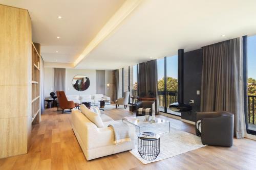 a living room with a couch and a table at Cassa Luxury Homes in Bogotá