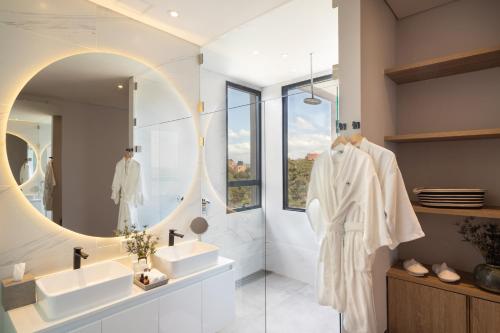 a bathroom with two sinks and a mirror at Cassa Luxury Homes in Bogotá